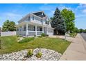 Charming two-story home with a welcoming front porch and beautiful landscaping at 5009 Mt Osage St, Frederick, CO 80504