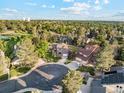 Expansive aerial view of the neighborhood with lush trees, manicured lawns, and nearby tennis court at 10114 Meade Ct, Westminster, CO 80031