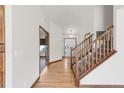 Bright foyer featuring hardwood floors, staircase, and doorway leading to other rooms at 1507 Alpine Ave, Berthoud, CO 80513