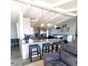 Open-concept living space with kitchen bar seating and an adjacent staircase, perfect for entertaining at 8209 Balsam Way, Arvada, CO 80005