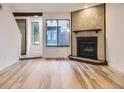 Bright living room featuring a fireplace with decorative tile surround and beautiful wood floors at 2949 Shady Holw, Boulder, CO 80304