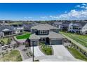 Stunning aerial view of a modern home with a well-maintained lawn in a Gathering-friendly suburban neighborhood at 22593 E Piccolo Way, Aurora, CO 80016