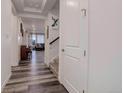 Bright entryway with wood floors leading to an open living space and staircase at 22593 E Piccolo Way, Aurora, CO 80016