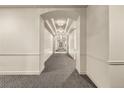 Long hallway featuring elegant lighting and a modern patterned carpet at 45 N Ogden St # 201, Denver, CO 80218