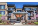 Beautiful condominium entrance featuring brick facade, modern architectural design and well maintained landscape at 6619 E Lowry Blvd # 112, Denver, CO 80230