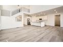 Bright and airy living room features high ceilings, wood floors, and staircase at 2956 S Quaker St, Morrison, CO 80465