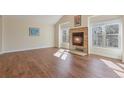 Bright living room with hardwood floors and a fireplace, creating a warm and inviting atmosphere at 1530 S Quebec Way # 34, Denver, CO 80231