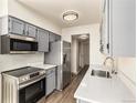 Updated kitchen, featuring stainless steel appliances and gray cabinets at 3549 S Fairplay Way # 10, Aurora, CO 80014