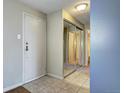 Apartment entryway with mirrored closet doors and tiled flooring at 2225 Buchtel Blvd # 1109, Denver, CO 80210