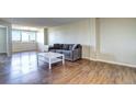 Living room with hardwood floors, gray couch, and white coffee table at 2225 Buchtel Blvd # 1109, Denver, CO 80210