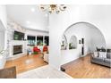Open-concept living room with fireplace, hardwood floors, and lots of natural light at 3253 S King Way, Denver, CO 80236
