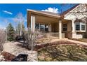 Inviting front porch with charming railings and cozy seating, perfect for relaxing outdoors at 8198 S Sicily Ct, Aurora, CO 80016