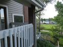 Inviting balcony view of neighborhood from a charming exterior of brick and siding home in a residential area at 12183 W Chenango Dr, Morrison, CO 80465