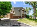 Inviting home exterior showcasing a lush yard and attached garage at 12183 W Chenango Dr, Morrison, CO 80465