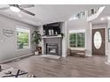 Bright living room features a brick fireplace, large windows and neutral paint colors at 12183 W Chenango Dr, Morrison, CO 80465
