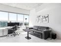 Living room offering comfortable seating, city views, and a well-lit workspace with sleek modern decor at 891 14Th St # 2816, Denver, CO 80202