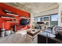 Living room with red accent wall, city views, and modern decor at 891 14Th St # 2816, Denver, CO 80202