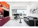 Modern living room with city views, a dedicated workspace, and stylish decor including a flat screen TV at 891 14Th St # 2816, Denver, CO 80202