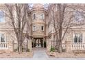 Attractive building entrance with stone facade and gated entry at 150 S Madison St # 112, Denver, CO 80209