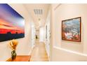 Bright hallway with hardwood floors and artwork at 150 S Madison St # 112, Denver, CO 80209