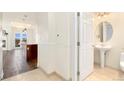 Hallway view towards an open floor plan with a partial kitchen and a bathroom featuring a pedestal sink at 1827 N Grant St # 604, Denver, CO 80203