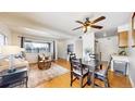 Open-concept living and dining area with wood floors and ample natural light at 3663 S Sheridan Blvd # P1, Denver, CO 80235
