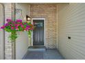 Inviting front entrance featuring a hanging basket of flowers and brick accents at 6468 S Forest St, Centennial, CO 80121