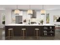 Bright kitchen features a spacious island with seating, stainless steel appliances, and stylish pendant lights at 3200 W 27Th Ave, Denver, CO 80211