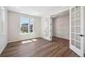 Well-lit office space boasting elegant French doors and stylish wood floors throughout at 5583 Riverbend Ave, Firestone, CO 80504
