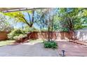Private backyard patio featuring brick walls, mature trees, and a well-maintained landscape at 2500 S York St # 116, Denver, CO 80210