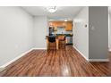 Efficient kitchen with stainless steel appliances, breakfast bar, and hardwood floors at 2500 S York St # 116, Denver, CO 80210