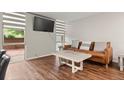 Cozy living room with a comfortable leather sofa, modern coffee table, and large windows at 2500 S York St # 116, Denver, CO 80210