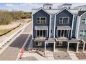 New construction townhomes feature modern exteriors with private balconies, landscaping, and convenient street access at 888 S Valentia St # 101, Denver, CO 80247
