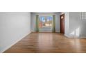 Hardwood floor living room with large window at 4830 W Vassar Ave, Denver, CO 80219