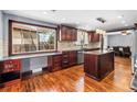 Gourmet kitchen featuring custom wood cabinets, granite countertops, and stainless steel appliances, perfect for culinary enthusiasts at 140 Lane Ct, Fort Lupton, CO 80621