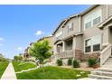Street view showcasing a row of well-maintained townhouses with inviting front porches and green lawns at 4343 S Nepal Ct, Centennial, CO 80015