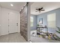Bright entryway with tile flooring, a barn door, and a glimpse of an adjacent office space at 4343 S Nepal Ct, Centennial, CO 80015