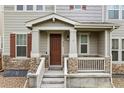 Inviting front porch features stone accents, a covered entryway, and a charming white railing at 4343 S Nepal Ct, Centennial, CO 80015