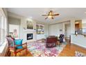 Cozy living room with fireplace, built-in shelving, and comfortable seating arrangement with natural light at 16500 Crosby Dr, Broomfield, CO 80023