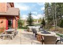 Enjoy the backyard with a fire pit, seating area, and a luxurious hot tub at 168 Corkscrew Dr, Breckenridge, CO 80424