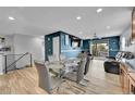 Bright dining area with glass table and modern chairs, opens to a living area and patio, with ample natural light at 1922 Danube Way, Aurora, CO 80011