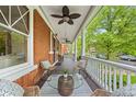 Inviting front porch featuring comfortable seating, ceiling fans, and classic white railings at 963 N Lafayette St, Denver, CO 80218