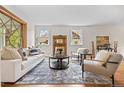 Cozy living room featuring stylish furniture, decorative fireplace, and natural light at 963 N Lafayette St, Denver, CO 80218