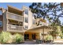 Multi-level condo building entrance featuring balconies, landscaping, and a covered entrance at 1304 S Parker Rd # 359, Denver, CO 80231