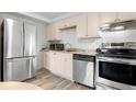 Bright, updated kitchen features stainless steel appliances and light wood cabinets at 1304 S Parker Rd # 359, Denver, CO 80231