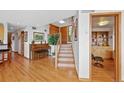Inviting entryway with hardwood floors, staircase, and an adjacent room at 857 Pawnee Trl, Castle Rock, CO 80108