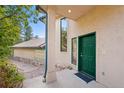 View of the front door of the home with green trim and stone accents at 857 Pawnee Trl, Castle Rock, CO 80108