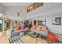 Bright living room featuring high ceilings, large windows, and an open layout at 857 Pawnee Trl, Castle Rock, CO 80108