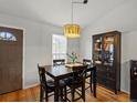 Bright dining room featuring hardwood floors, modern light fixture, and large cabinet at 11256 W 104Th Ave, Broomfield, CO 80021