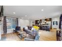 Open-concept layout seamlessly connects the living room and kitchen area at 3064 S Holly Pl, Denver, CO 80222